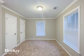 Dallas house for rent - a empty room with a white door and a window and blinds