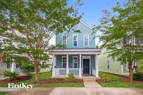 Summerville house for rent - a blue house with trees in front of it
