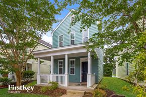 Summerville house for rent - a blue and white house with a porch and trees