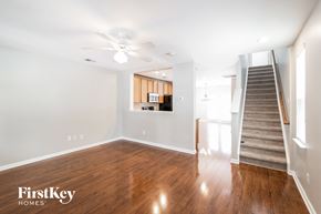 Summerville house for rent - a living room with wood flooring and a staircase and a ceiling fan