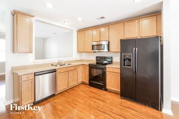 Summerville house for rent - a kitchen with wooden cabinets and stainless steel appliances