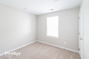 Summerville house for rent - a bedroom with white walls and a window