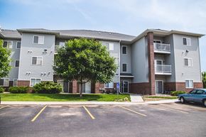 Ames apartment for rent - an apartment building with a car parked in a parking lot