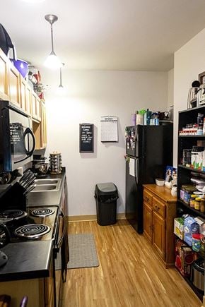 Ames apartment for rent - a small kitchen with a stove and a refrigerator