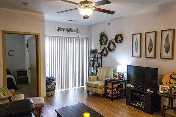Ames apartment for rent - a living room filled with furniture and a ceiling fan