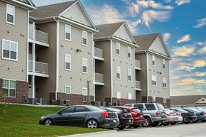 Ames apartment for rent - a row of apartment buildings with cars parked in front