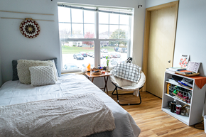 Ames apartment for rent - a small bedroom with a bed and a window