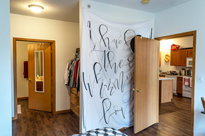 Ames apartment for rent - a bedroom with a closet and a white wall with writing on it