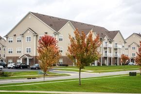 Ames apartment for rent - an apartment building with trees in front of it