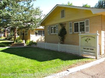 Longmont apartment for rent - a yellow house with a white fence in front of it
