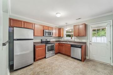 Jacksonville house for rent - A kitchen with brown cabinets and a stainless steel refrigerator.