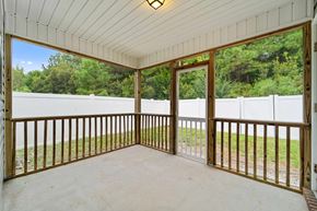 Jacksonville house for rent - A white wooden porch with a white fence and trees in the background.