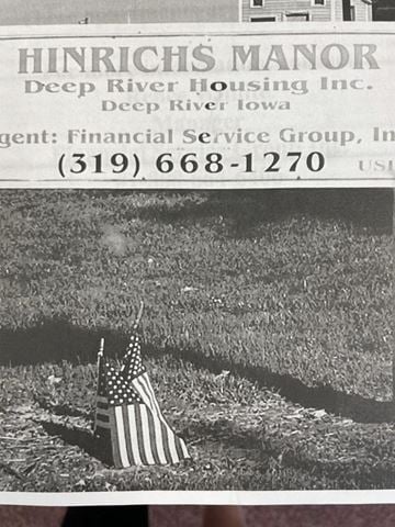 Deep River apartment for rent - a flag laying in the grass next to a newspaper