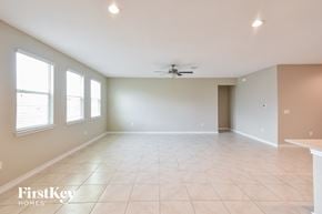 Converse house for rent - A spacious room with a ceiling fan and a table in the corner.