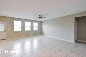 Converse house for rent - A spacious room with a fan and tile flooring.