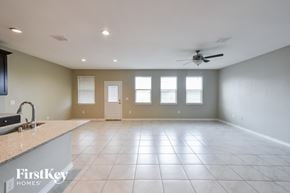 Converse house for rent - A spacious room with a fan and tile flooring.