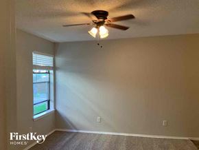 Mckinney house for rent - a bedroom with a ceiling fan and a window