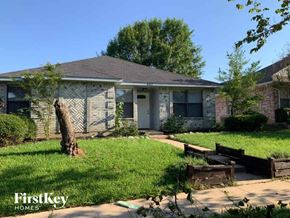 Mckinney house for rent - a small brick house with a yard and grass