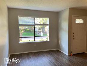 Mckinney house for rent - an empty living room with wood floors and a window