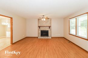 Canton house for rent - A spacious living room with a fireplace and wooden floors.