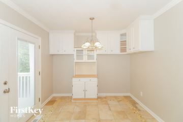 Canton house for rent - A kitchen with white cabinets and a tan floor.