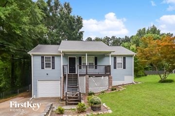 Dallas house for rent - a blue house with a yard and a deck