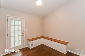 Dallas house for rent - a bedroom with white walls and wood flooring and a window