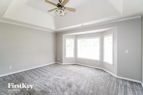 Cordova house for rent - A spacious room with a ceiling fan and carpeted floor.