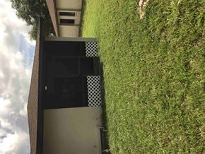 Bradenton house for rent - a view from above of a building with a grassy yard