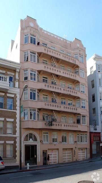 San Francisco apartment for rent - A pink building with many windows and balconies.