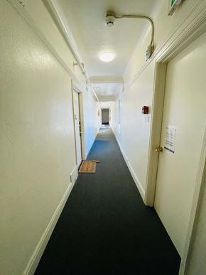 San Francisco apartment for rent - A long hallway with a door on the right.