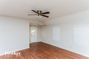 Royse City house for rent - a living room with wood floors and a ceiling fan