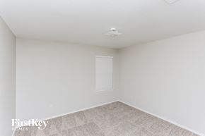 Royse City house for rent - a bedroom with white walls and carpet and a window