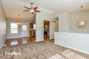 Arnold house for rent - A spacious room with a ceiling fan and a rug on the floor.