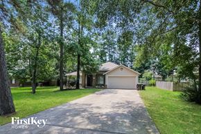 Magnolia house for rent - a home with a driveway and a garage door