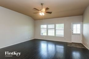 Grand Prairie house for rent - the living room of an empty house with a ceiling fan