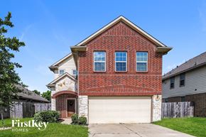Baytown house for rent - a brick house with a white garage door