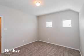 Baytown house for rent - a bedroom with white walls and carpet and two windows