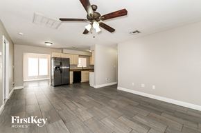 Fort Myers house for rent - A spacious room with a ceiling fan and wooden flooring.