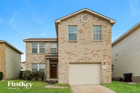 San Antonio house for rent - a tan brick house with a white garage door