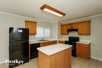 San Antonio house for rent - a kitchen with black appliances and a white counter top