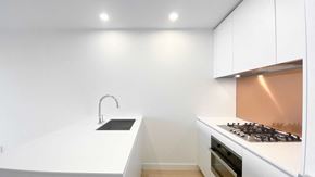 Vancouver apartment for rent - A modern kitchen with a stove and sink.
