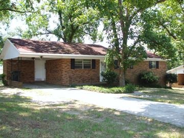 Macon apartment for rent - a brick house with a sidewalk and some trees
