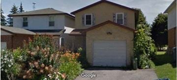 Guelph apartment for rent - a house with a garage door in front of it