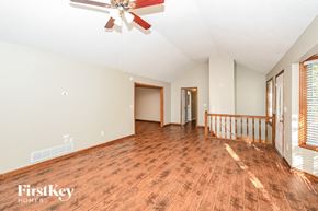 Acworth house for rent - a living room with a wooden floor and a ceiling fan