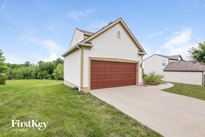 Kansas City house for rent - A house with a garage door is for sale by FirstKey Homes.