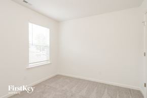 Winston-Salem house for rent - a bedroom with white walls and carpet and a window