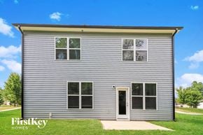 Winston-Salem house for rent - the front of a small house with white siding and green grass