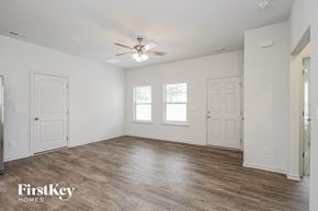Winston-Salem house for rent - a bedroom with white walls and white doors and a ceiling fan