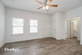 Winston-Salem house for rent - the living room of an empty house with a ceiling fan